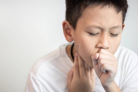 Tired child boy coughing and sore throat,a painful cough,pain in throat,lung inflammation, infection of bacterial or viral,Bronchial Pneumonia,disease of sickness, illness,health care,medical concept