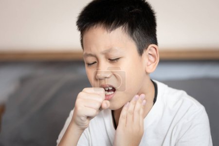 Sick child boy suffering from coughing,sore throat,chronic cough with mucus,Acute bronchitis or chest cold,Pneumonia,Respiratory disease,infection or inflammation of the bronchial or lung in children
