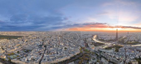 Beautiful view of famous Eiffel Tower in France with colorful twilight romantic sky. Wide establishing aerial morning sunrise or sunset of paris city center best travel destinations landmark in Europe.