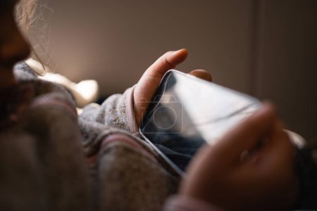 Photo for Close up of child hands holding smartphone and watching cartoons or playing games. Screen time child problem. High quality photo - Royalty Free Image