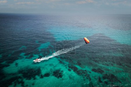Photo for Tourists enjoying parasailing in Sa Coma beach in Mallorca, Spain on a summer day - Royalty Free Image