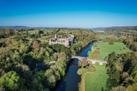 Aerial view of Lismore Castle, County Waterford, Ireland, on a tranquil spring day under a flawless blue sky