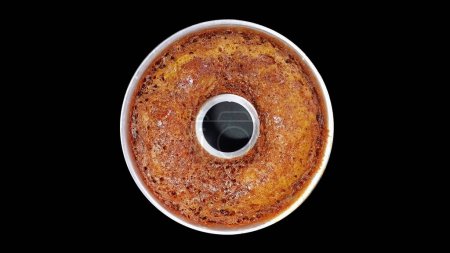 Indonesian Local Caramel Cake on the Silver pan with Isolated Black Background. Top View. Flat Lay.
