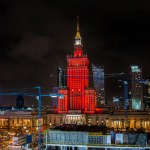Warszawa, Poland - January 30: Panoramic view of vibrant cityscape at night, highlighted by the red illumination of historic building the Palace of Culture and Sciences
