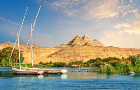 Landscape of Aswan with sailboats in the Nile on the way to pyramids, Egypt.