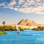 Beautiful Nile scenery with sailboat in the Nile on the way to pyramids, Aswan, Egypt.