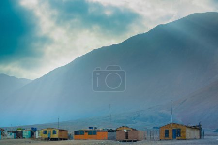 Photo for A small fishing cove with very poor houses on the coast of the Atacama desert in northern Chile - Royalty Free Image
