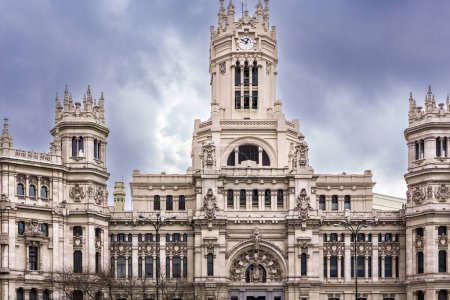 Téléchargez les photos : Majestueux palais de Cibeles servant de mairie de Madrid sur la place de Cibeles sous un ciel nuageux. - en image libre de droit