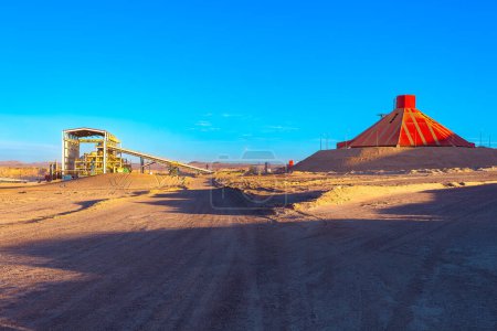Conveyor belt and stockpile under a dome at an open-pit copper mine in Chile.