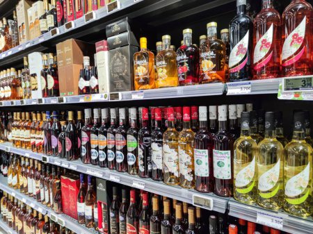 Photo for Surgeres, France - October 17, 2020:Side view of a shelf with various alcoholic beverages (Cognac, local wines..) in a French supermarket - Royalty Free Image
