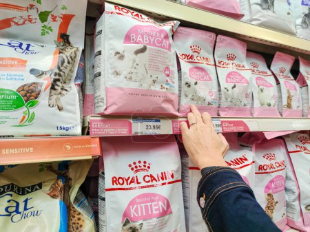 Photo for Surgeres, France - October 17, 2020:Customer Exploring "Royal canin" Premium Cat Food Section in a French Pet Store - Royalty Free Image
