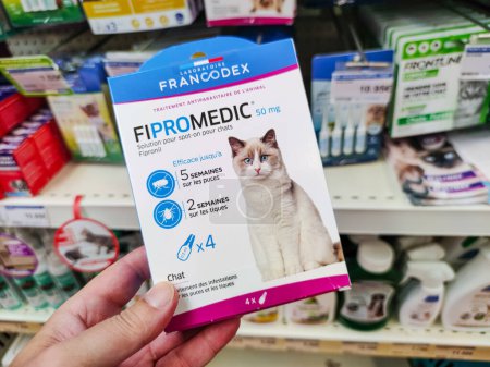 Photo for Surgeres, France - October 17, 2020:Customer Choosing Flea Repellent Pipettes, "Fipromedic" brand, in a French Pet Store - Royalty Free Image