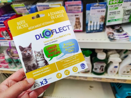 Photo for Surgeres, France - October 17, 2020:Customer Choosing Flea Repellent Pipettes, "DuoFlect" brand, in a French Pet Store - Royalty Free Image