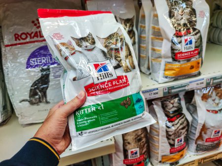 Photo for Surgeres, France - October 17, 2020:Customer Exploring Premium Cat Food Section in a French Pet Store - Royalty Free Image