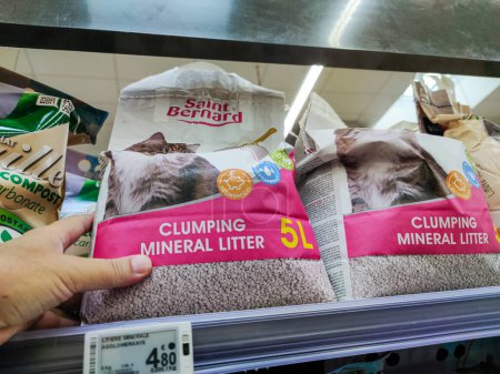 Photo for Puilboreau, France - October 14, 2020:Customer Selecting Cat Litter in a French Supermarket - Royalty Free Image
