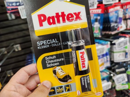 Photo for Puilboreau, France - October 14, 2020:Customer holding Quick-Drying Glue "Pattex" brand in a French Hardware Store - Royalty Free Image