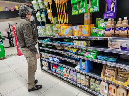 Photo for Surgeres, France - October 17, 2020:Man in Front of Household Cleaning Products Aisle in a French Supermarket - Royalty Free Image