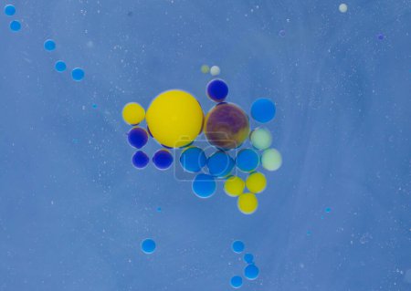 Photo for A myriad of oil droplets intermingling with water, creating a mesmerizing effect reminiscent of a galaxy. - Royalty Free Image