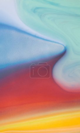 Vibrant acrylic paint flowing downwards on a surface, creating a colorful and dynamic abstract pattern. Abstract background of colorful creative acrilic painting.