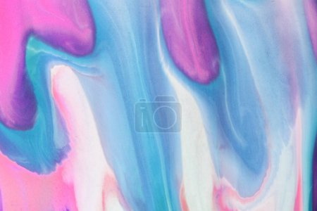 Swirls of vibrant blue, pink, and white merge fluidly, resembling an abstract wave under the soft, glowing light of late afternoon.