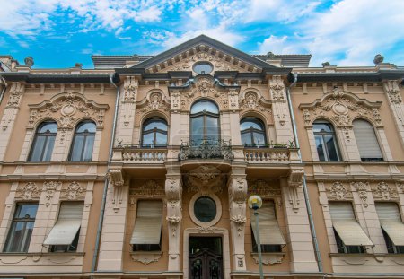 Photo for Front view the facade of beautiful old building with old sculptures in the city center of Szeged, Hungary - Royalty Free Image