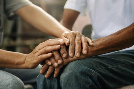 Photo for Cropped image of person supporting elderly man. care and love of family concept, people holding hands together - Royalty Free Image