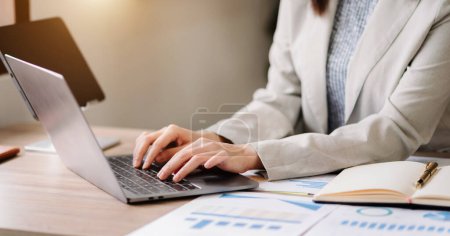 Photo for Businesswoman hands typing on smartphone and  laptop keyboard computer, typing, online - Royalty Free Image