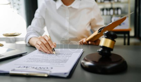 Photo for Law hammer on table. lawyer woman working with contract papers - Royalty Free Image