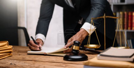 Photo for Justice and law concept.Male judge in a courtroom on wooden table and Counselor or Male lawyer working in office. - Royalty Free Image