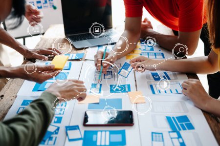  UX-Entwickler und UI-Designer Brainstorming über mobile App-Schnittstelle Wireframe-Design mit Kundenbrief und Farbcode im modernen Büro.