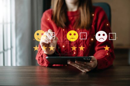 Photo for Smart woman use smartphone and tablet choosing happy smile face icon. feedback rating and positive customer review experience, mental health assessment. world mental health day concept - Royalty Free Image