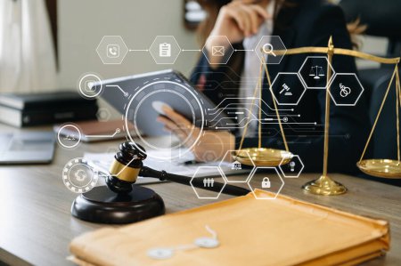 Photo for Justice and law concept.woman judge in a courtroom  the gavel, working with  digital tablet computer on wood table with VR icon - Royalty Free Image