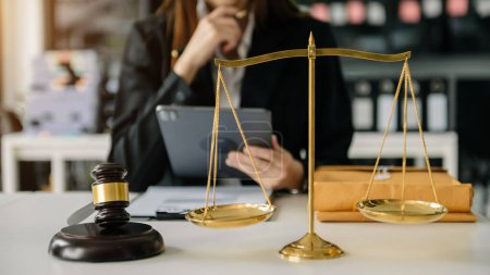 Photo for Woman lawyer in the office with brass scale on wooden table. justice and law concept - Royalty Free Image