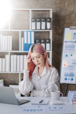 Photo for Woman who is tired and overthinking from working with  laptop at modern office - Royalty Free Image