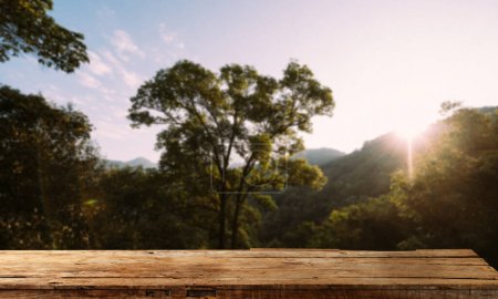 Foto de Empty top of wooden shelf on sky mountain and river trees front view background. For product display blur background image, for product display montage. in sunset - Imagen libre de derechos