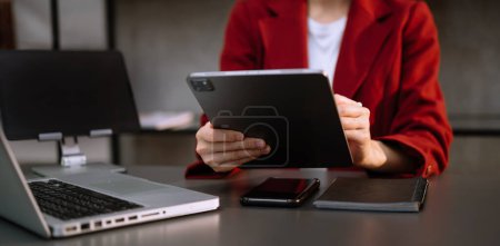 Foto de Mujer de negocios con ordenador portátil, teléfono y tableta PC en la oficina - Imagen libre de derechos