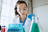 Female biotechnologist testing new chemical substances in a laboratory. Poster #646001684