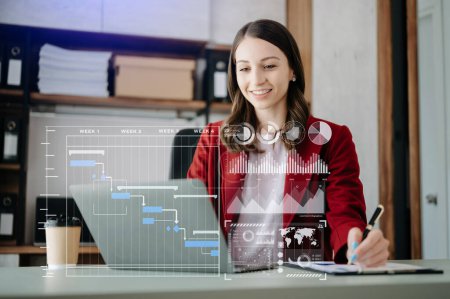 Photo for Businesswoman  working and update tasks and Gantt chart scheduling virtual diagram.with laptop in office - Royalty Free Image