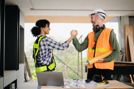 Photo for Engineer and contractor join hands after signing contract,They are having a modern building project together. Successful cooperation team concept - Royalty Free Image