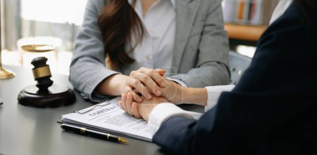 Photo for Business people compassionately holding hands and discussing contract papers  at office room - Royalty Free Image