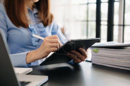 Téléchargez les photos : Femme d'affaires travaillant avec VR large écran blanc tablette PC dans le bureau - en image libre de droit