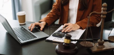 Photo for Justice and law concept.businesswoman or lawyer or accountant working on accounts using calculator and documents in modern office - Royalty Free Image