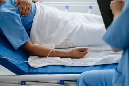 Photo for Male patient is in bed in the a hospital. - Royalty Free Image