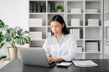 Asian businesswoman working in the office with  laptop
