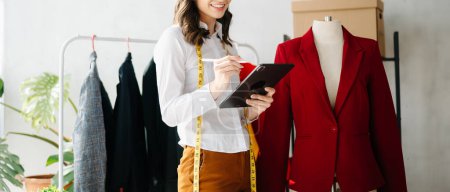 Photo for Young designer woman holding tablet pc  as online shopping concept - Royalty Free Image