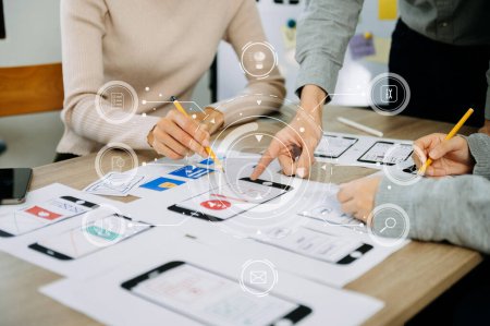 Photo for Close up view of UI developer team brainstorming on their project with laptop, smartphone and digital tablet. Creative digital development agency. - Royalty Free Image