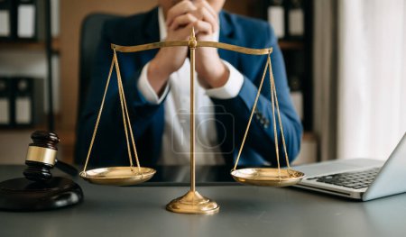 Photo for Male lawyer in the office with brass scale on wooden table. justice and law concept - Royalty Free Image
