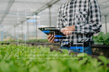 Photo for Farmer man using digital tablet computer in field, technology application in agricultural growing activity, Smart farming - Royalty Free Image