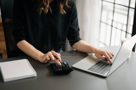 Photo for Close up of businesswoman or accountant with laptop at home office. - Royalty Free Image