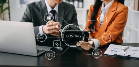 Web hosting concept, businesspeople using laptop, tablet  on the virtual screen inscription Hosting on desk, Internet, business, digital technology concept. in office